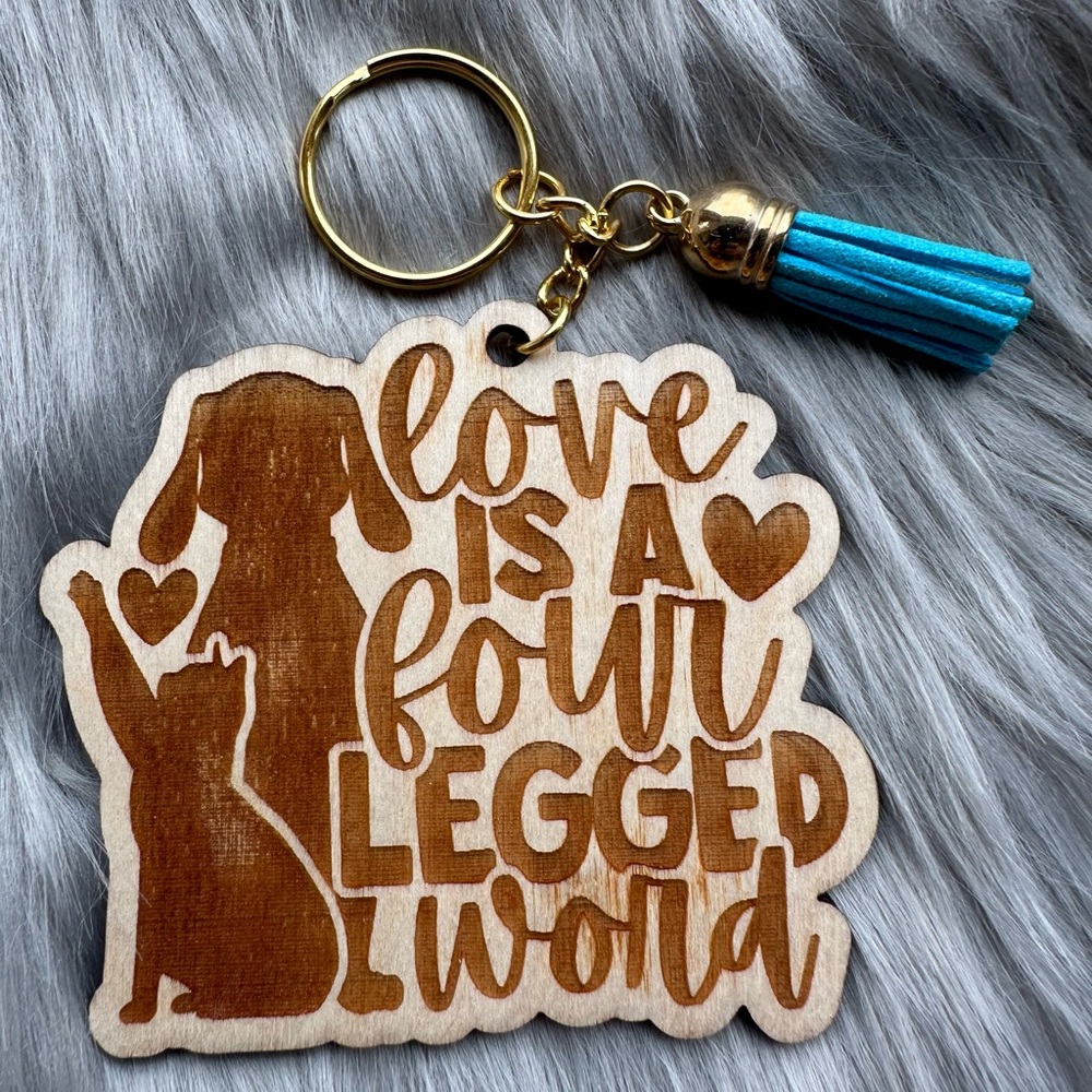 Handmade wood keychain with tassel: Love is a four legged word.